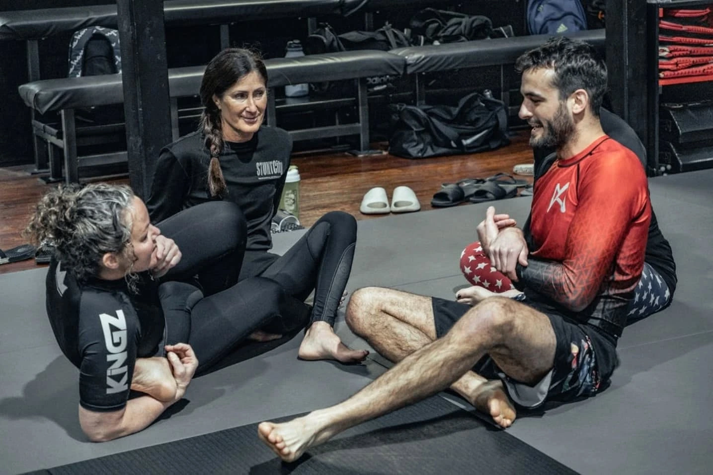 Women learning Brazilian Jiu-Jitsu technique together at Infinum BJJ Brantford